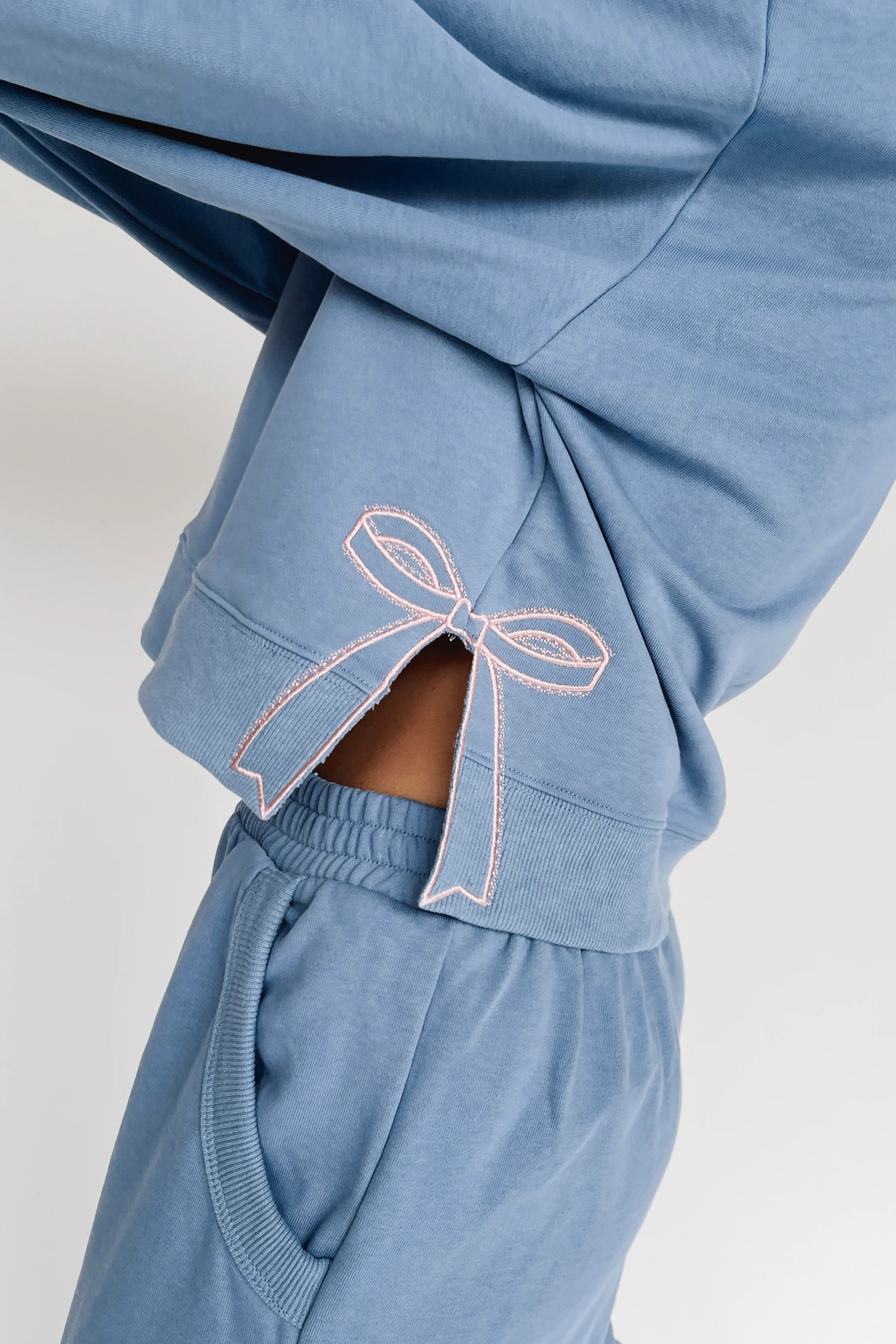 The Monzingo Bow Embroidered Pullover in Dusty Blue - Image 7